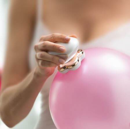 women's hair remover over a baloon